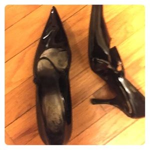 Polished, sleek black patent pumps.
